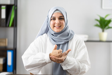 Happy Woman Wearing Hijab Learning Sign