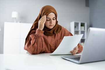 Worried Muslim Woman Doing Taxes