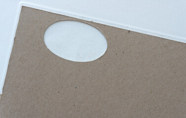Obraz premium cardboard with oval window on a light background
