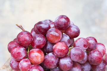 Grape with water drops, old wall background