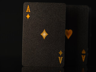 On a black background are poker cards, two aces with gold embossing. 3D image. Close-up. Minimalism. Casino, gambling, poker, gambling business, risk, win, winners. - obrazy, fototapety, plakaty