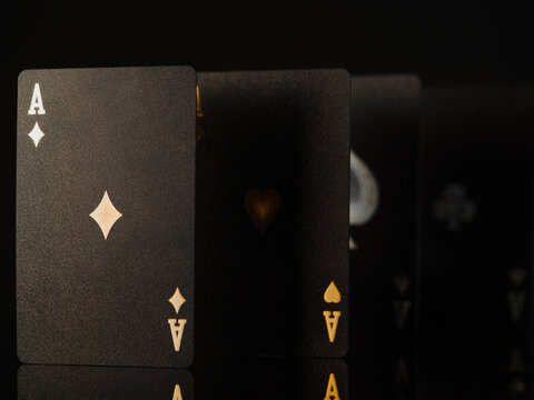 3D image. Black poker cards with gold and silver embossing, four aces. Black background. No people. Casino, online casino, night club. Gambling, win, winner, poker.