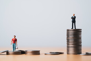 One man standing on higher coins stacking in other man for different salary and unequal income in...