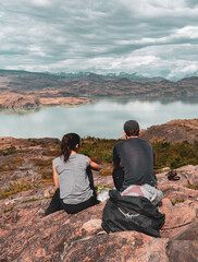 Fototapeta premium Hiking couple resting and looking out at landscape