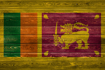 The national flag of Sri Lanka is painted on a camp of even boards nailed with a nail. The symbol of the country.