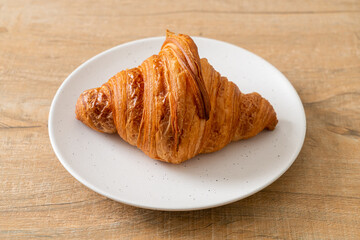 fresh croissant on white plate