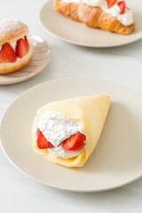 fresh strawberry cream crepe on plate