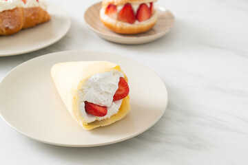 fresh strawberry cream crepe on plate