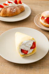 fresh strawberry cream crepe on plate