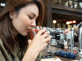 Female beautiful portrait model fashion is drinking coffee cup cappuccino esspresso latte americano beverage cafe delicious restuarant retail lifestyle happy holiday  enjoy relax 