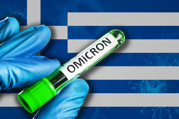 Greece outbreak of omicron variant. Hand holds a test tube with covid-19 virus omicron in front of...