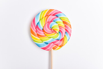 A colored lollipop on a stick. Sweet dessert. Confectionery background. Copy space. Flat lay, top...