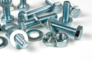 metal bolts and nuts with round washers close-up on a white background