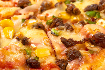 angle view fresh pizza with beef and bacon toppings close up