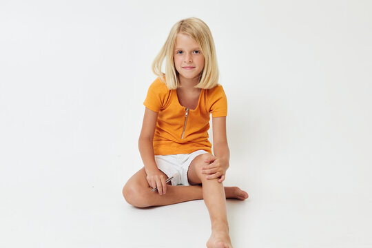 cute girl with blond hair sitting on the floor