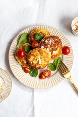 zucchini pancakes with tomatoes and spinach