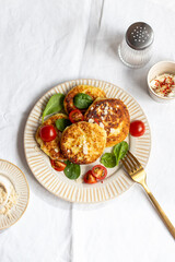 zucchini pancakes with tomatoes and spinach