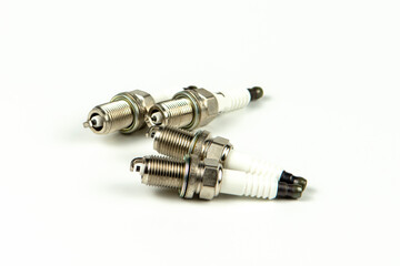 Car service. A set of new car spark plugs as a spare part of motor vehicles on white. Group of candles for the motor close-up