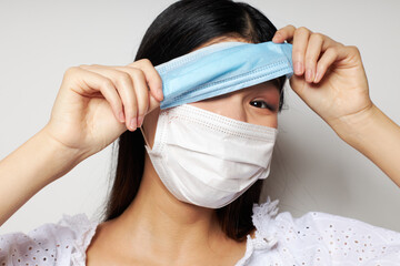 woman with Asian appearance two medical masks on the head protection Lifestyle unaltered