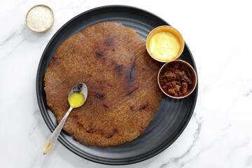 Sweet roti made out of rice flour, jaggery, and ghee. Gud ki roti. gur ki roti, jaggery Bhakri, meethi gud ki roti cooked in banana leaf. Winter food. Copy space.