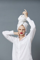 fashionable woman with a towel on his head in a white shirt isolated background