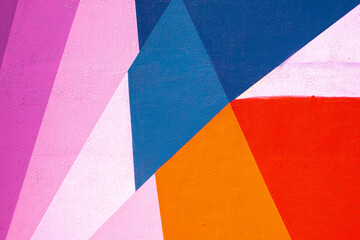 Closeup of colorful blue red pink purple urban wall texture. Modern pattern for wallpaper design....