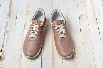 Light brown faux leather shoes with laces. Close-up shot.