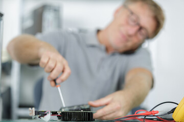 portrait of a man on the phone repairing something