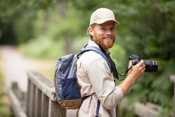 young cheerful man photographer taking photographs