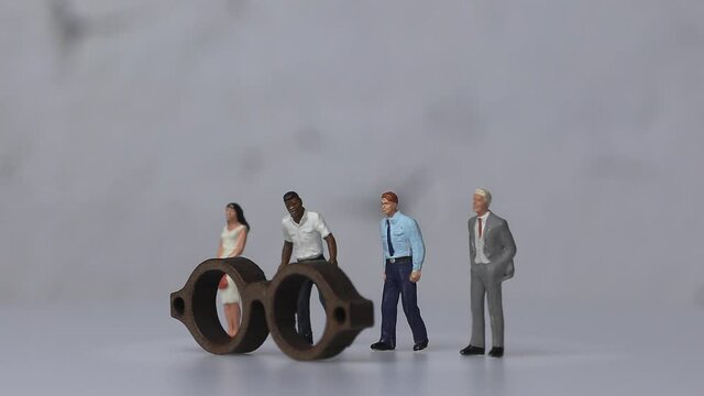 Concept about social prejudice. Various&nbsp;miniature&nbsp;people&nbsp;standing&nbsp;behind&nbsp;the&nbsp;glasses.
