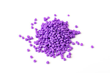 purple beads are scattered on a white surface. isolate. sale of accessories for creativity and needlework.