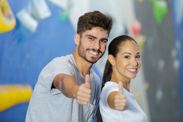 young sporting couple with thumbs up