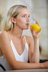 portrait of young woman with orange juice indoors