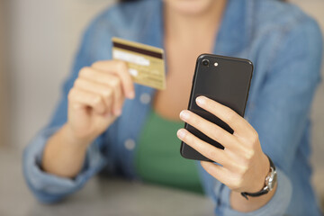 woman buying online with credit card and smart phone