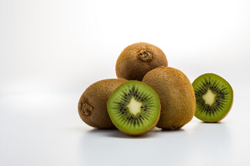 Ripe whole kiwi fruit and half kiwi fruit isolated on white background