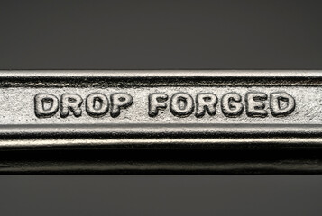 inscription forged on a metal object. forged wrench