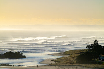 Mount maunganui main beach shrouded in sea haze caused by large surf from Cyclone Cody.