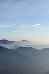 Abstract natural background, endless mountain spaces and mountain peaks covered in haze.