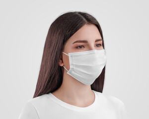 Mockup of a white surgical mask with ear loops on a dark haired nurse isolated on background.