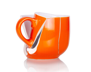 Broken empty orange cup collected from debris isolated on white