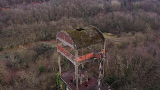 Aerial shot of an abonded factory in the midle of a forest in normandy