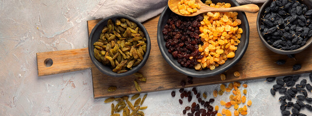 Different types of raisins on light backgroound.