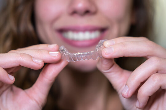 Young woman showing her invisible ortodonthics