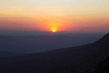 Thailand traveler in happy time with beautiful Sunset at Phu Kradueng National Park in Loei Province of thailand at noise out focus