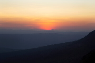 Thailand traveler in happy time with beautiful Sunset at Phu Kradueng National Park in Loei Province of thailand at noise out focus