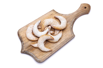 Traditional German or Austrian Vanillekipferl vanilla kipferl cookies on wooden serving board