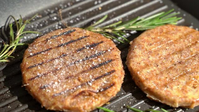 Vegan meat for burger. Protein patties grilled with herbs and spices. Artificial meat concept. 
