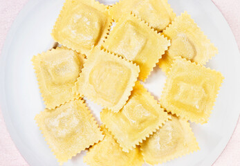 Uncooked ravioli on plate