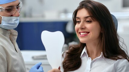 Closeup beauty lady patient toothy smile checking result efficiency dental treatment look at mirror