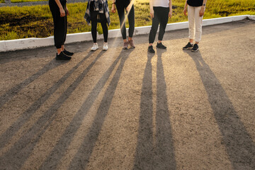 group of girls are walking around the city having fun and relaxing at sunset